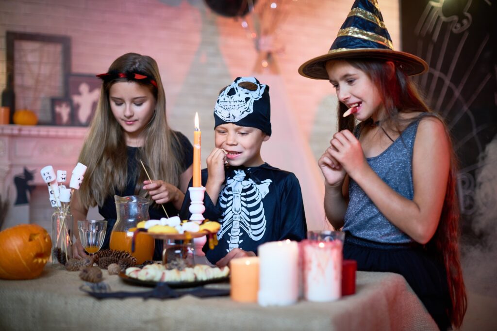 Children Eating Sweets at Halloween Party